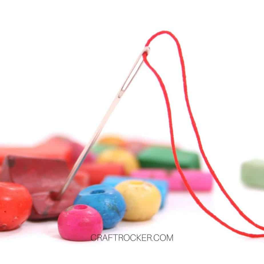 Threaded Needle next to Beads - Craft Rocker