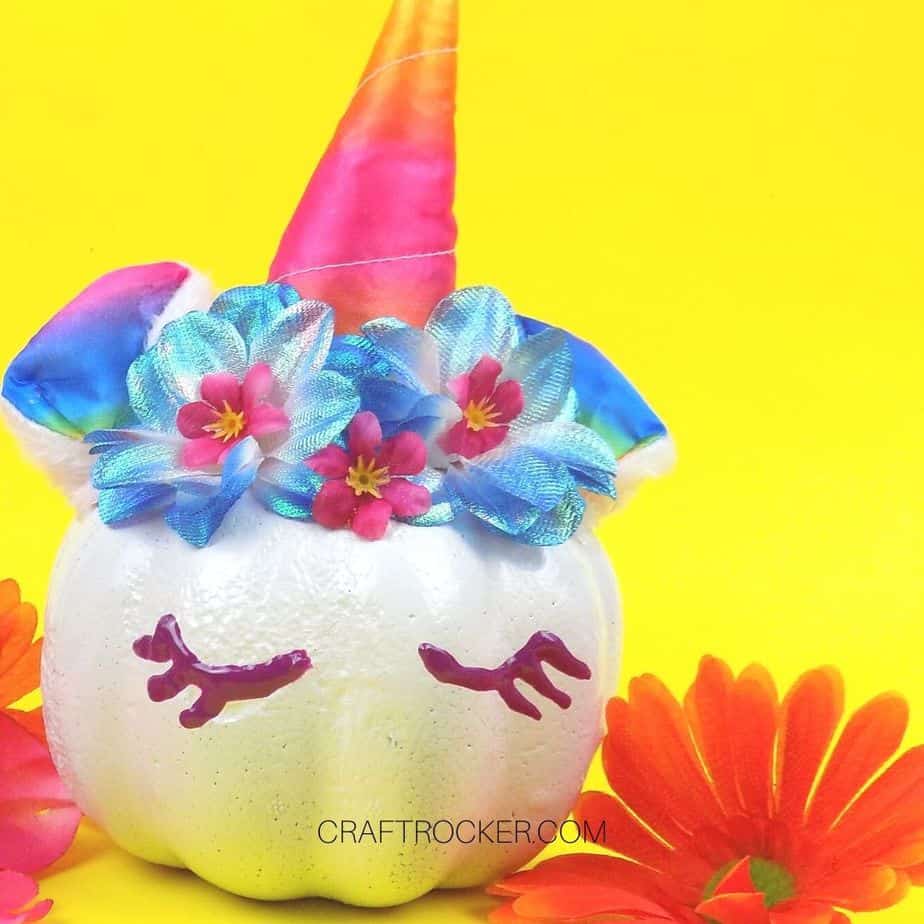 Close Up of Unicorn Pumpkin next to Flowers - Craft Rocker