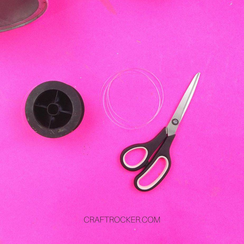 Cut Length of Fishing Line next to Scissors and Roll of Fishing Line - Craft Rocker