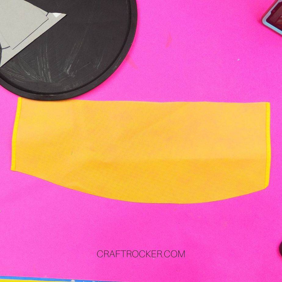 Cut Piece of Yellow Fabric next to Black Pizza Pan - Craft Rocker