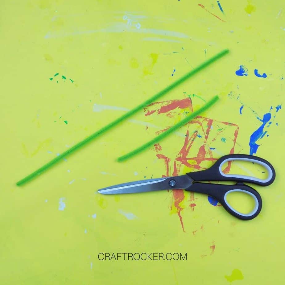 Scissors next to Green Pipe Cleaners - Craft Rocker