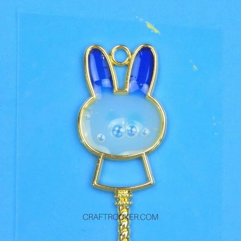 Close Up of Bubbles in White UV Resin in Head of Metal Bunny Charm - Craft Rocker