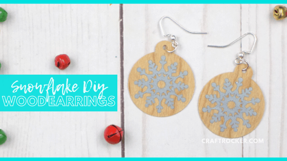 Close Up of Christmas Earrings on Wood Background with text overlay - Snowflake DIY Wood Earrings - Craft Rocker