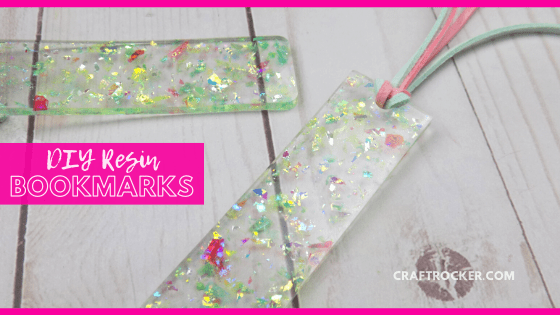 Close Up of Holographic Glitter Resin Bookmarks on Wood Background with text overlay - DIY Resin Bookmarks - Craft Rocker