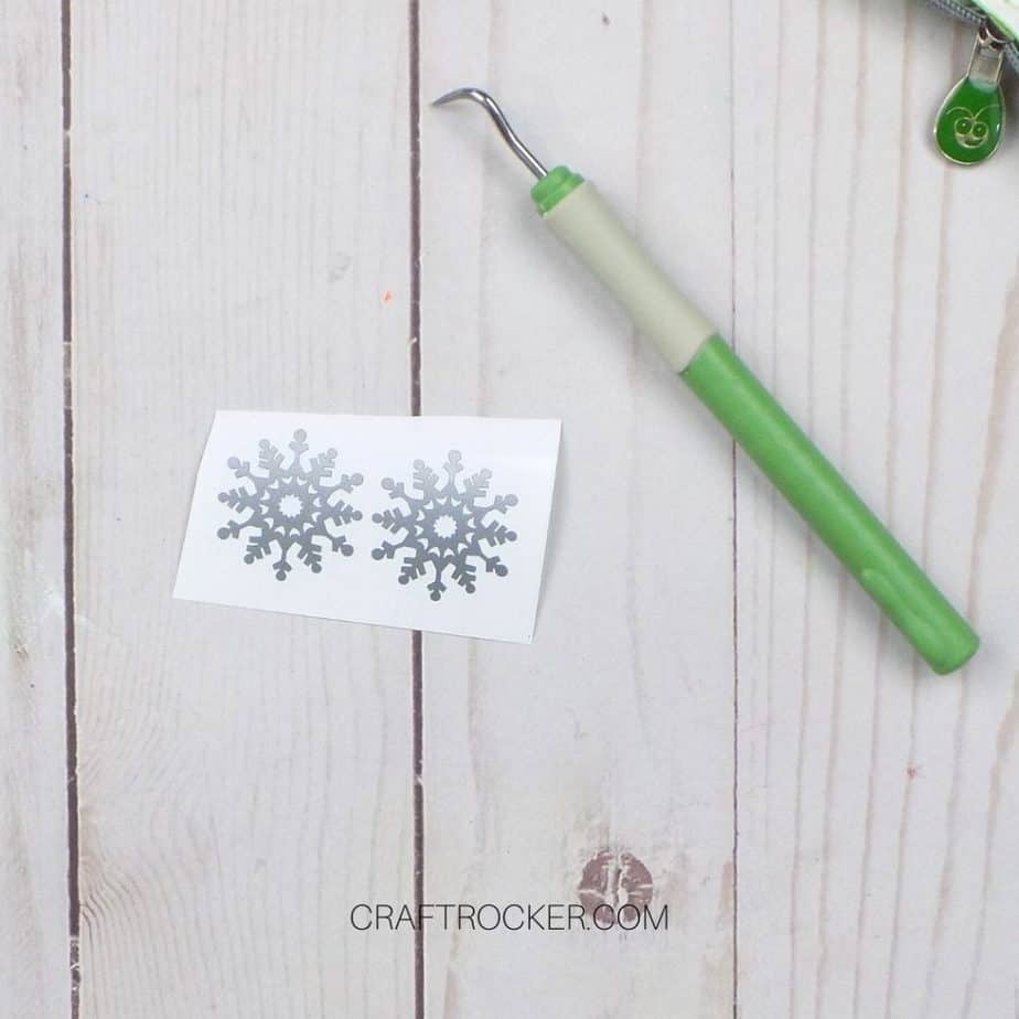 Close Up of Silver Snowflakes Next to Weeding Tool - Craft Rocker