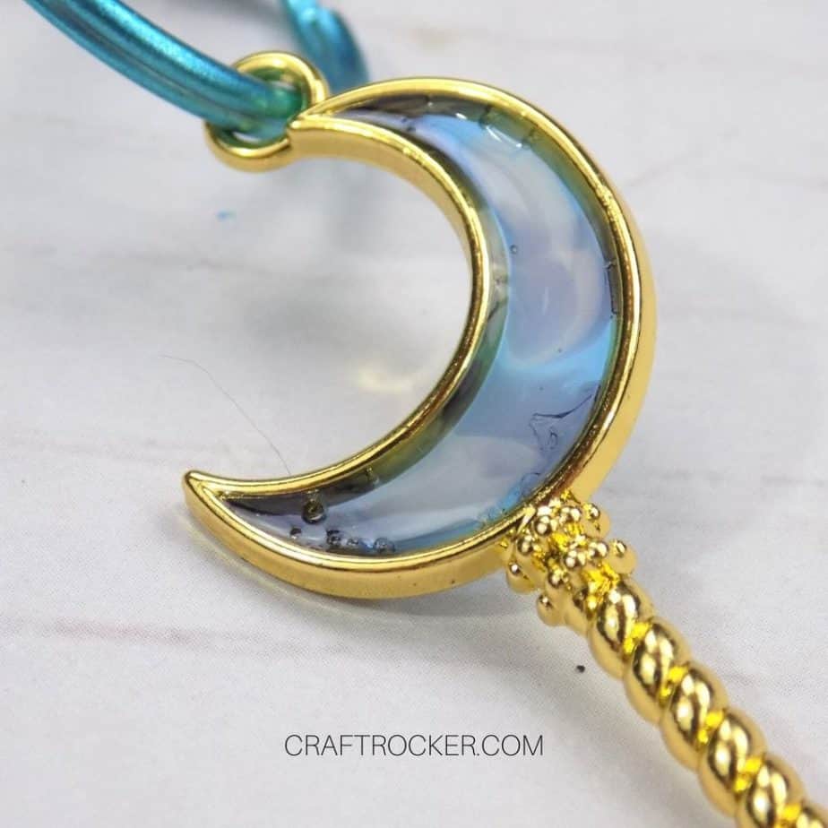 Close Up of UV Moon Keychain on Wood Background - Craft Rocker