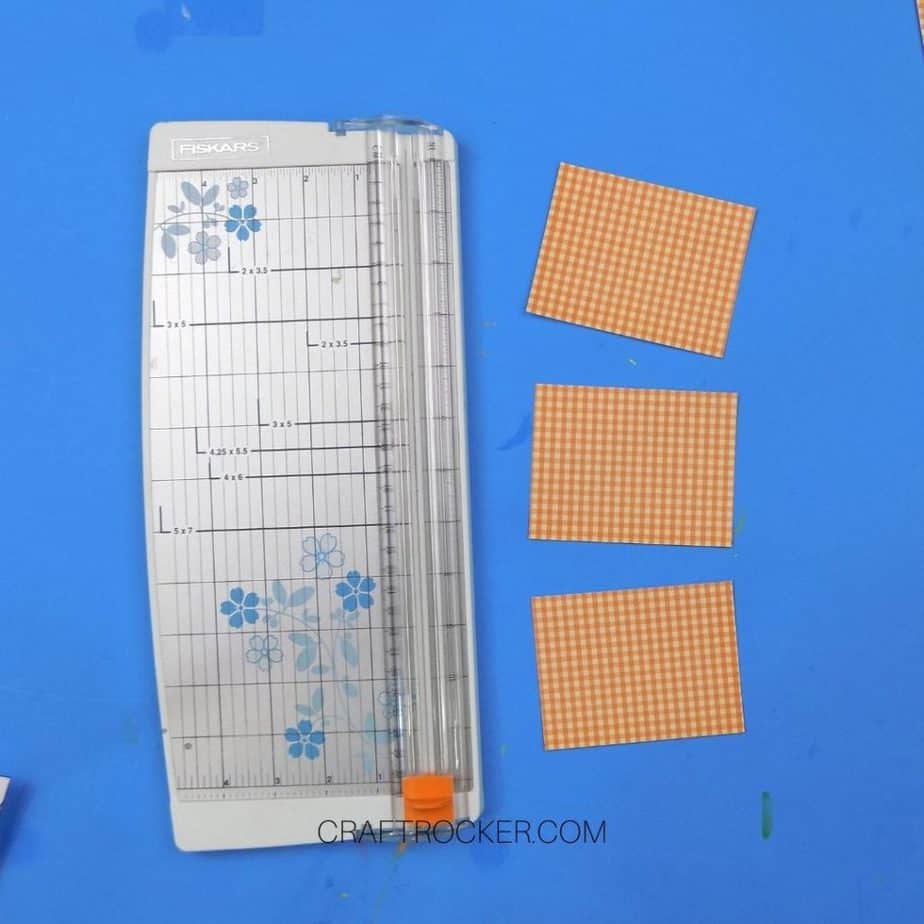 Orange Plaid Paper Rectangles next to Paper Cutter - Craft Rocker