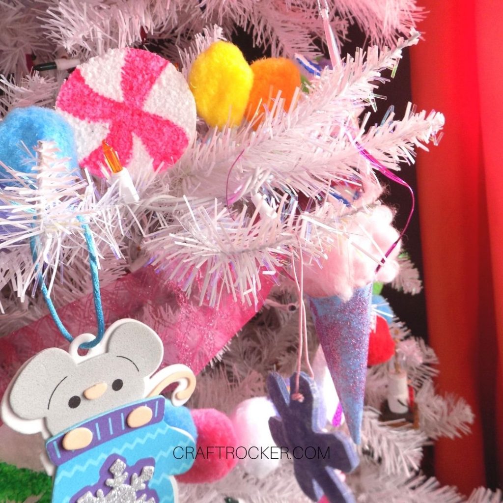 Close Up of Colorful Candy Pompom Garland on Tree - Craft Rocker