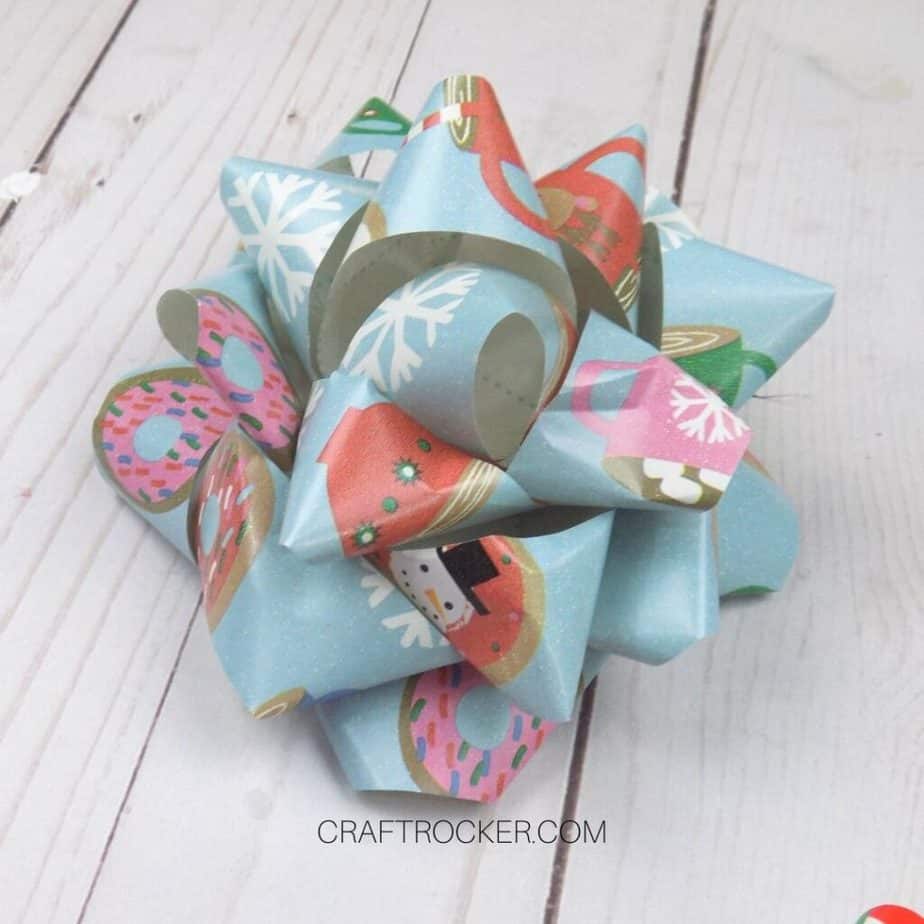 Close Up of Traditional Wrapping Paper Bow on Wood Background - Craft Rocker