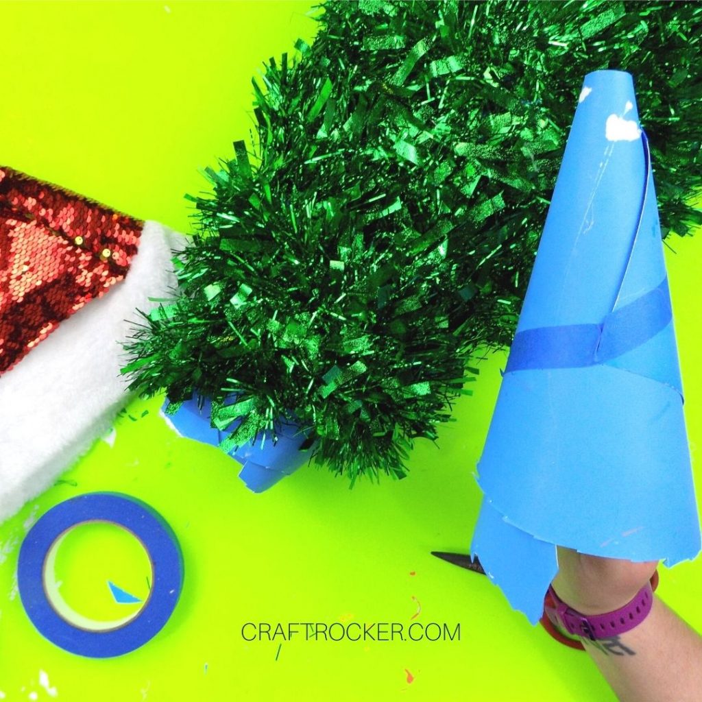 Hand Holding the Rolled Poster Board Tip over Garland Covered Cone - Craft Rocker