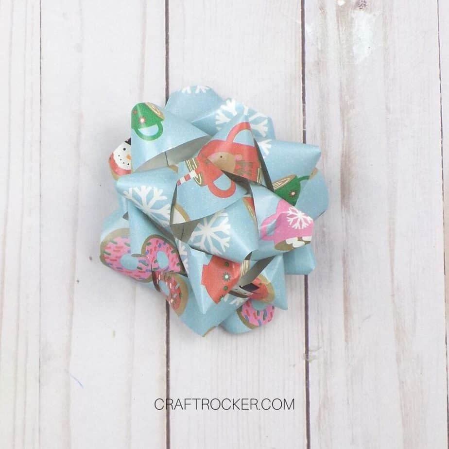 Try this revolutionary way to make a special wrapping paper ribbon ornament  : Bowdabra