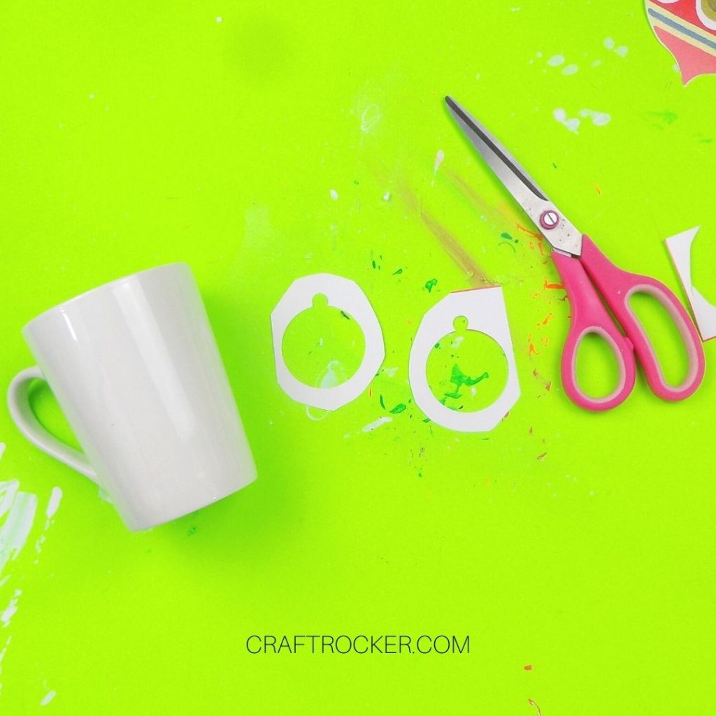 White Mug next to Ornament Outlines and Paper Towel - Craft Rocker