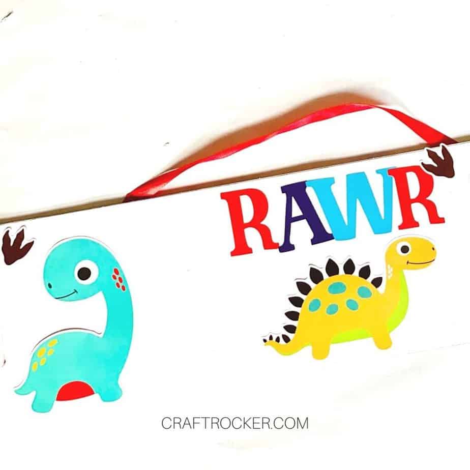 Close Up of Dinosaur Stickers Attached to Wood Sign - Craft Rocker