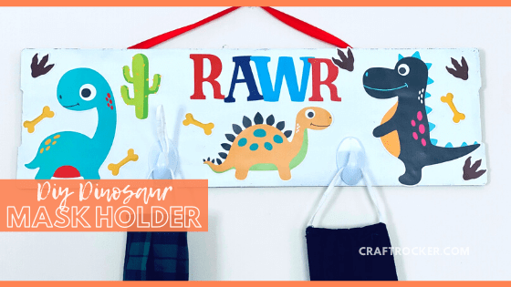 Close Up of Hanging Mask Holder with text overlay - DIY Dinosaur Mask Holder - Craft Rocker