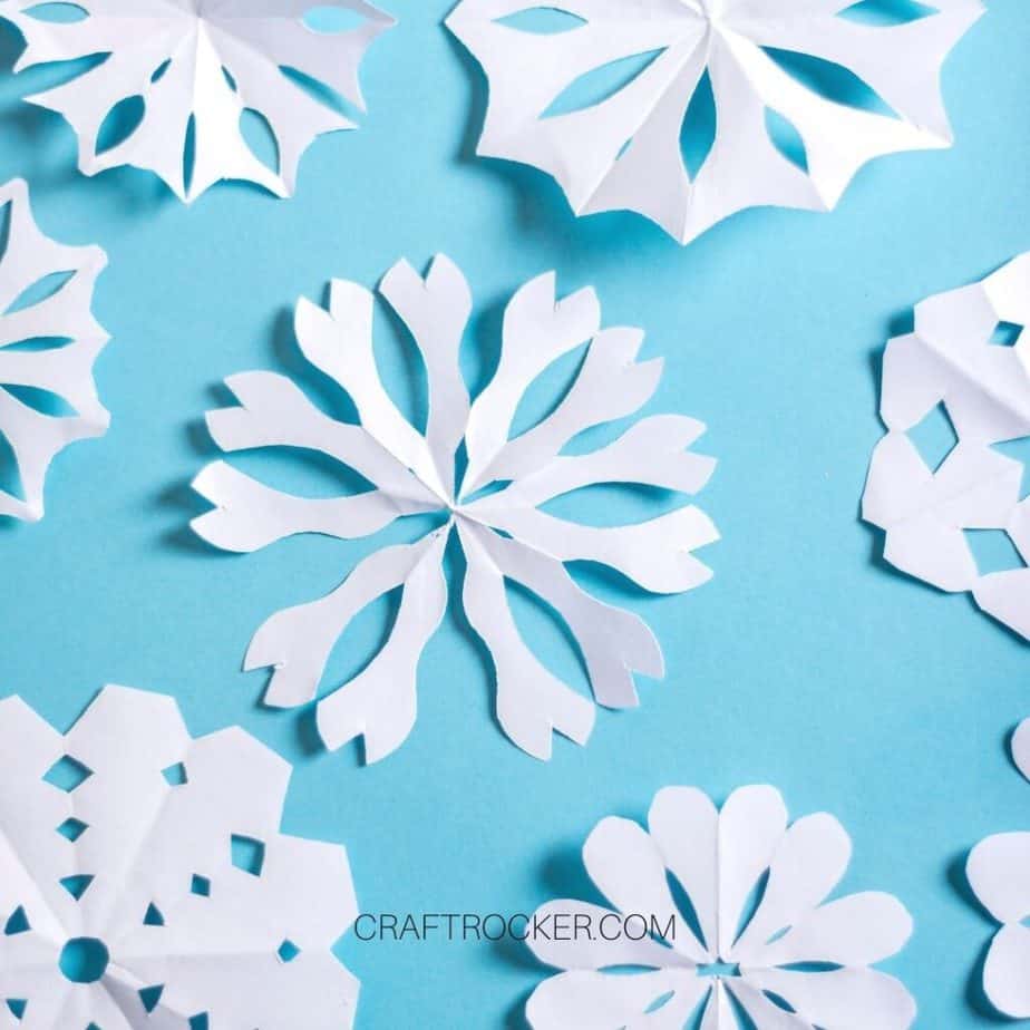 Different Styles of Paper Snowflakes on Blue Background - Craft Rocker