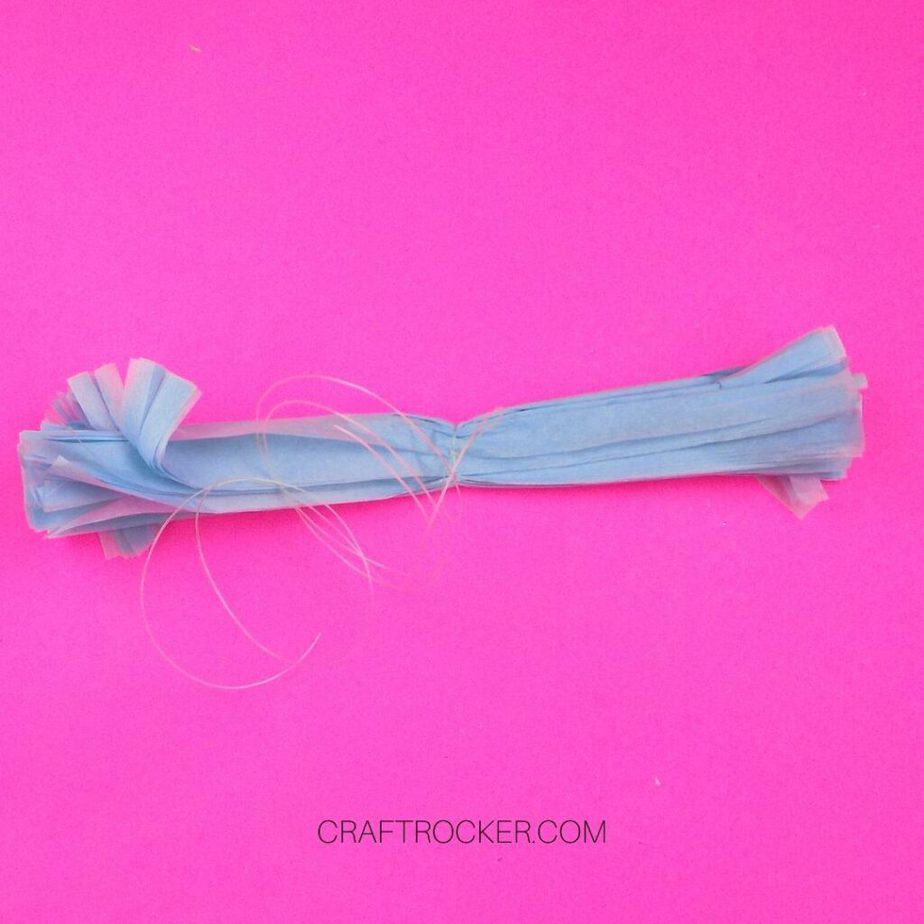 Folded Fringed Blue Tissue Paper with Fishing Line Tied Around the Center - Craft Rocker