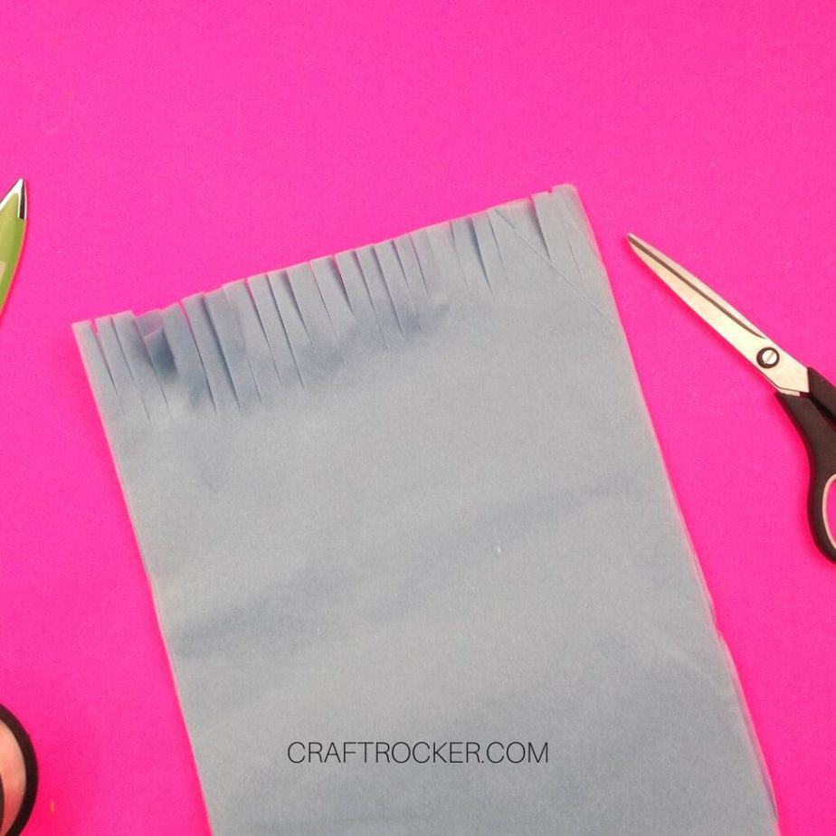 Fringed Edge of Light Blue Tissue Paper next to Scissors - Craft Rocker