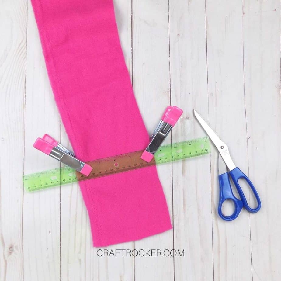 Ruler Clipped to Piece of Hot Pink Fleece next to Scissors - Craft Rocker