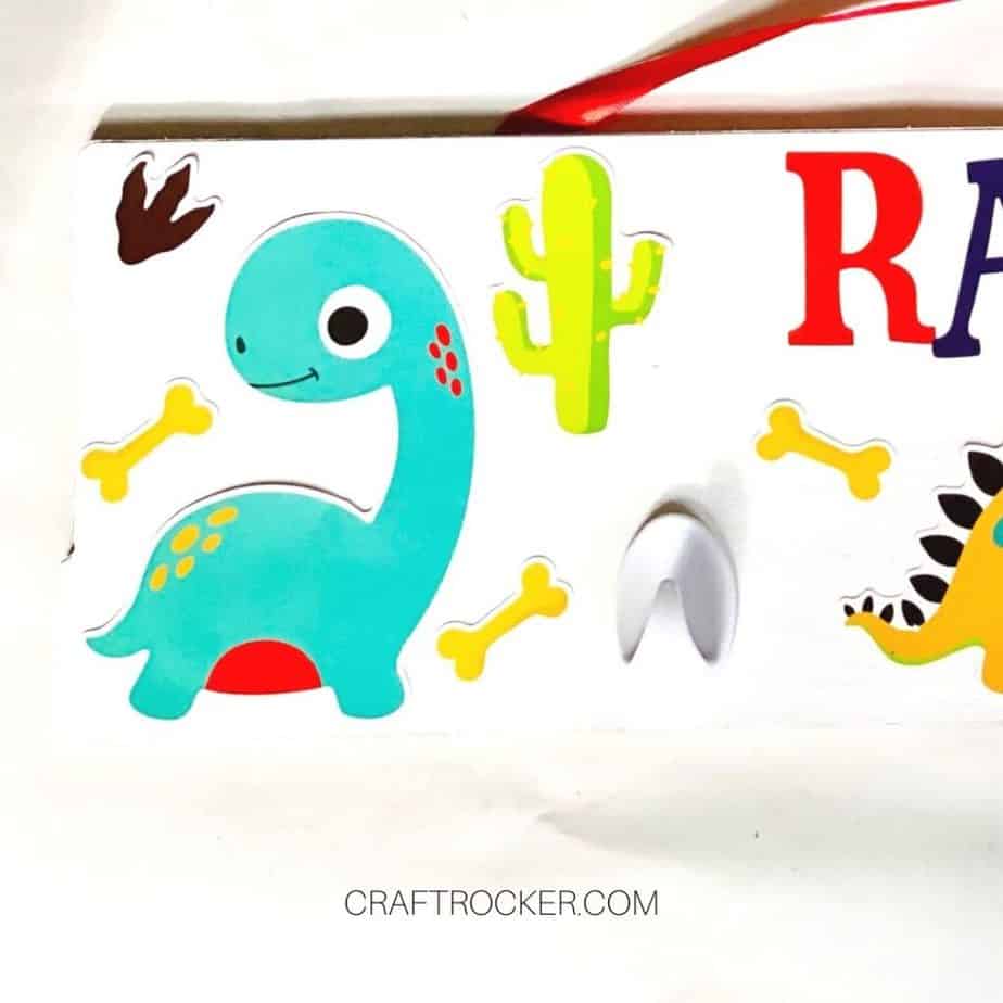 Small Stickers next to Dinosaur on Wood Sign - Craft Rocker