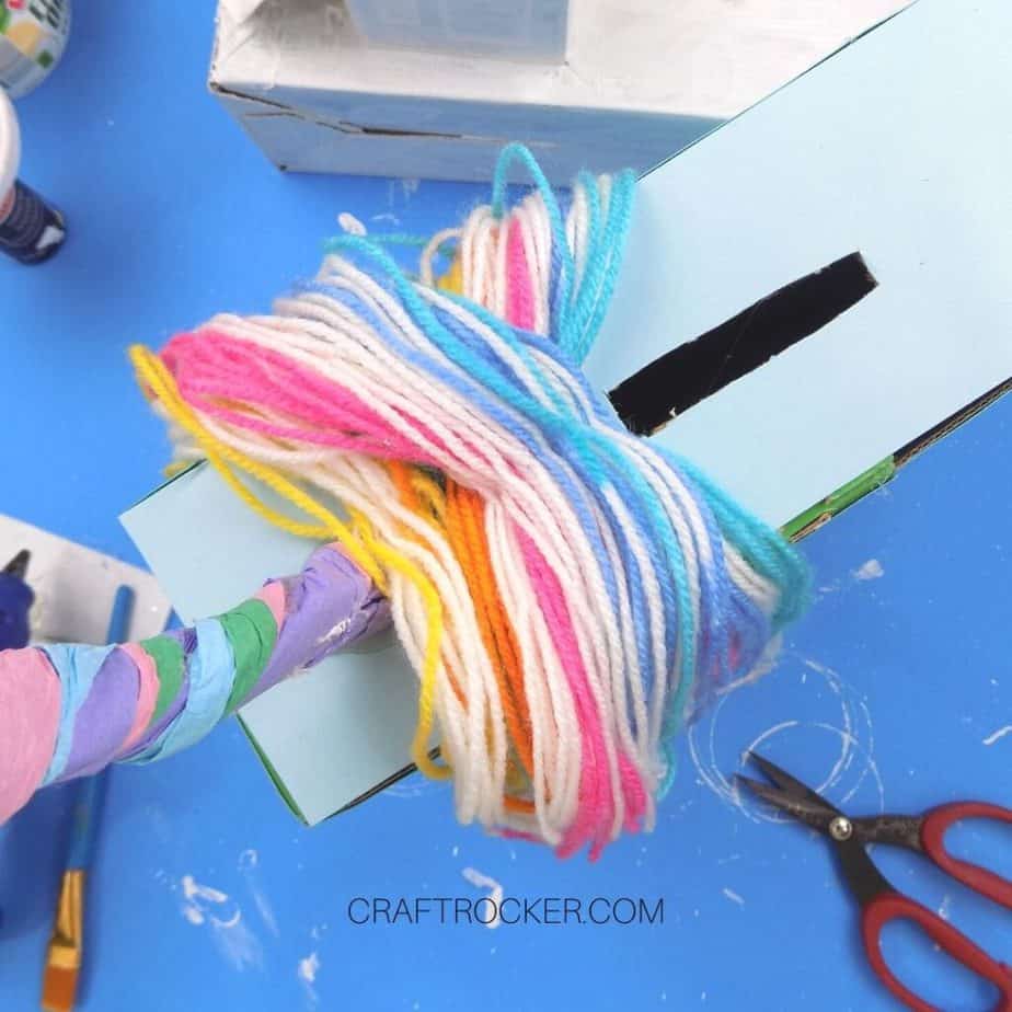 Smaller Lengths of Rainbow Yarn Glued to Top of Valentine Box Behind Horn - Craft Rocker