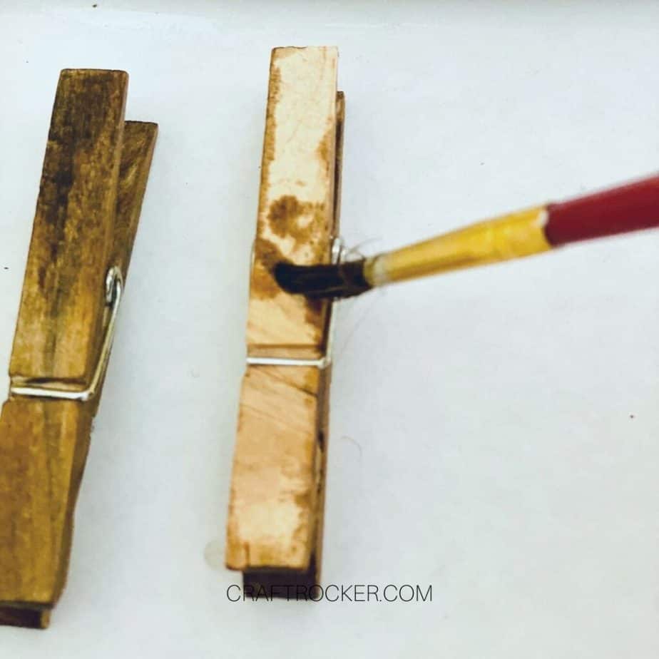 Close Up of Paint Brush Putting Stain on Clothespins - Craft Rocker