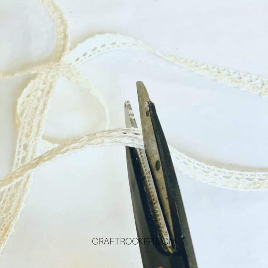 Close Up of Scissors Cutting Lace Ribbon - Craft Rocker