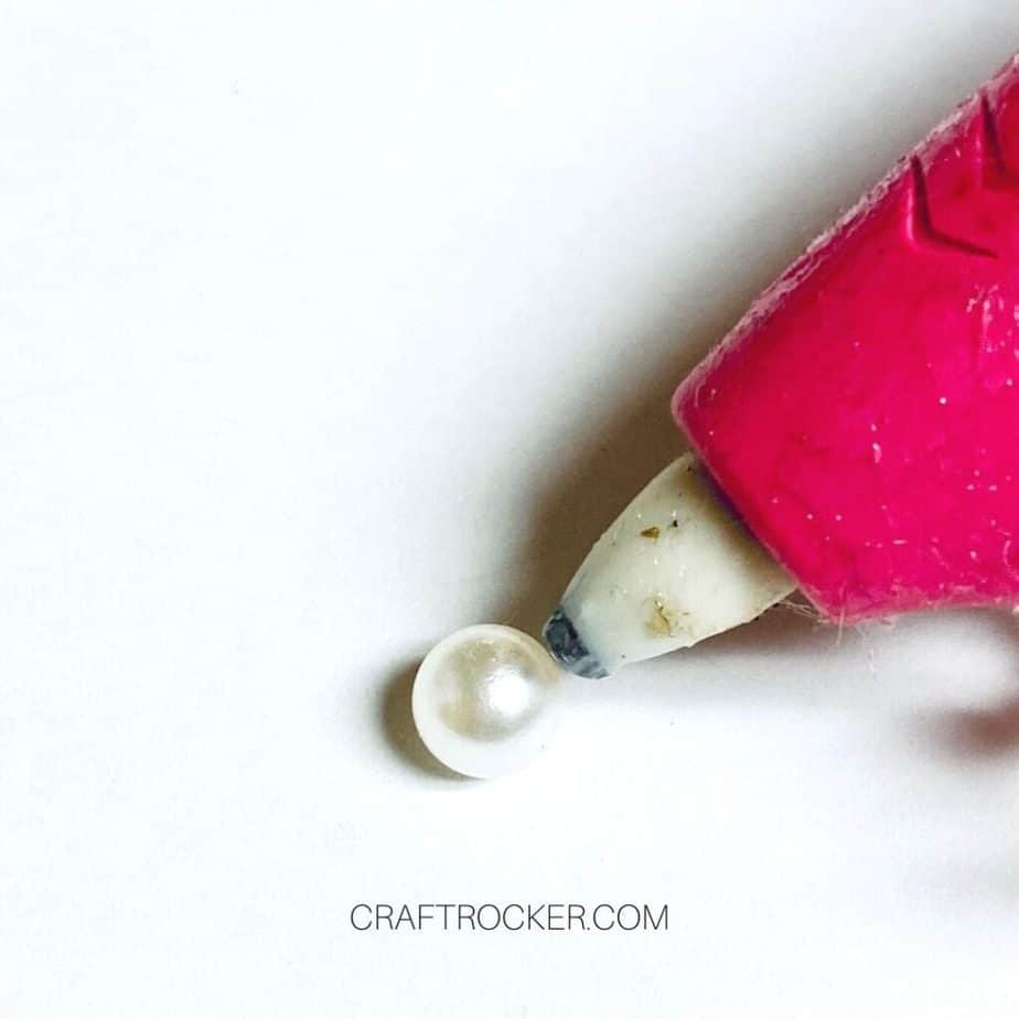 Close Up of Glue Gun Putting Hot Glue on Bead - Craft Rocker