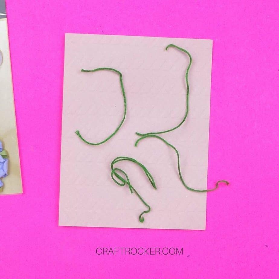 Pieces of Green Floss on top of Blank Card - Craft Rocker