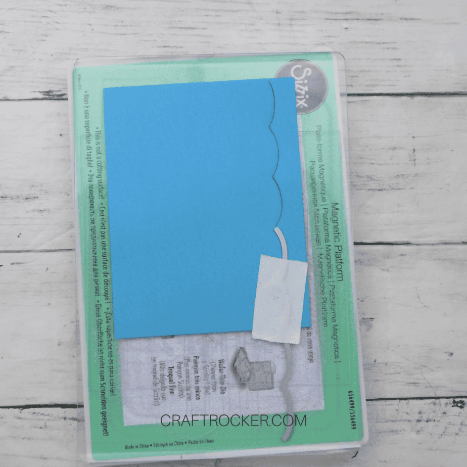 Teal Paper on Sizzix Plate with Repositioned Scalloped Die Taped to the Bottom Right Side of the Paper - Craft Rocker