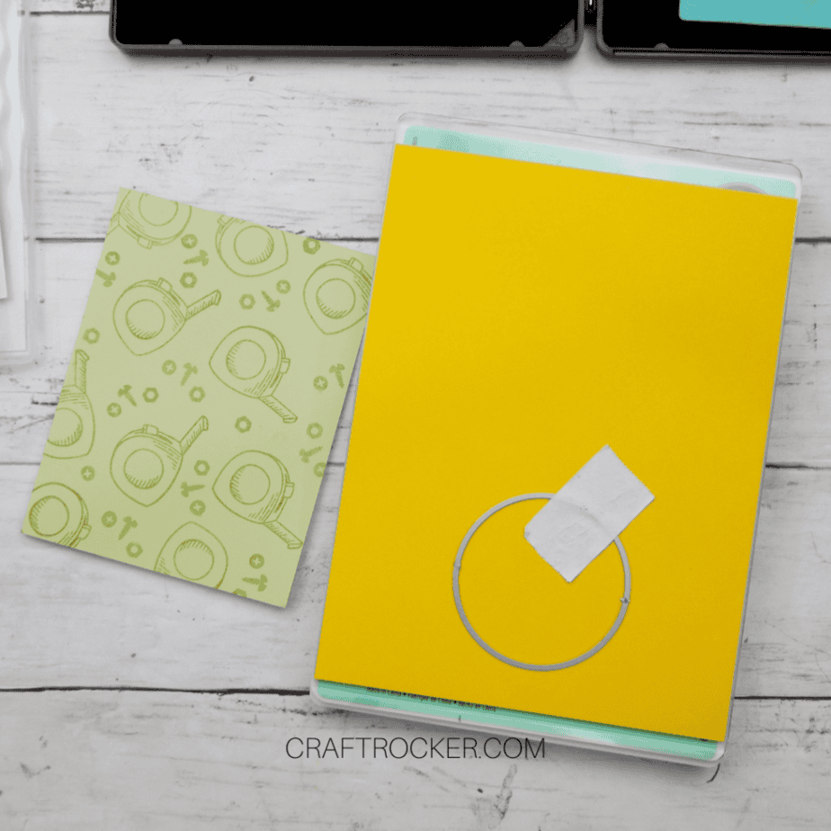 Circle Die Taped to Yellow Paper on Sizzix Plates next to Tool Card - Craft Rocker