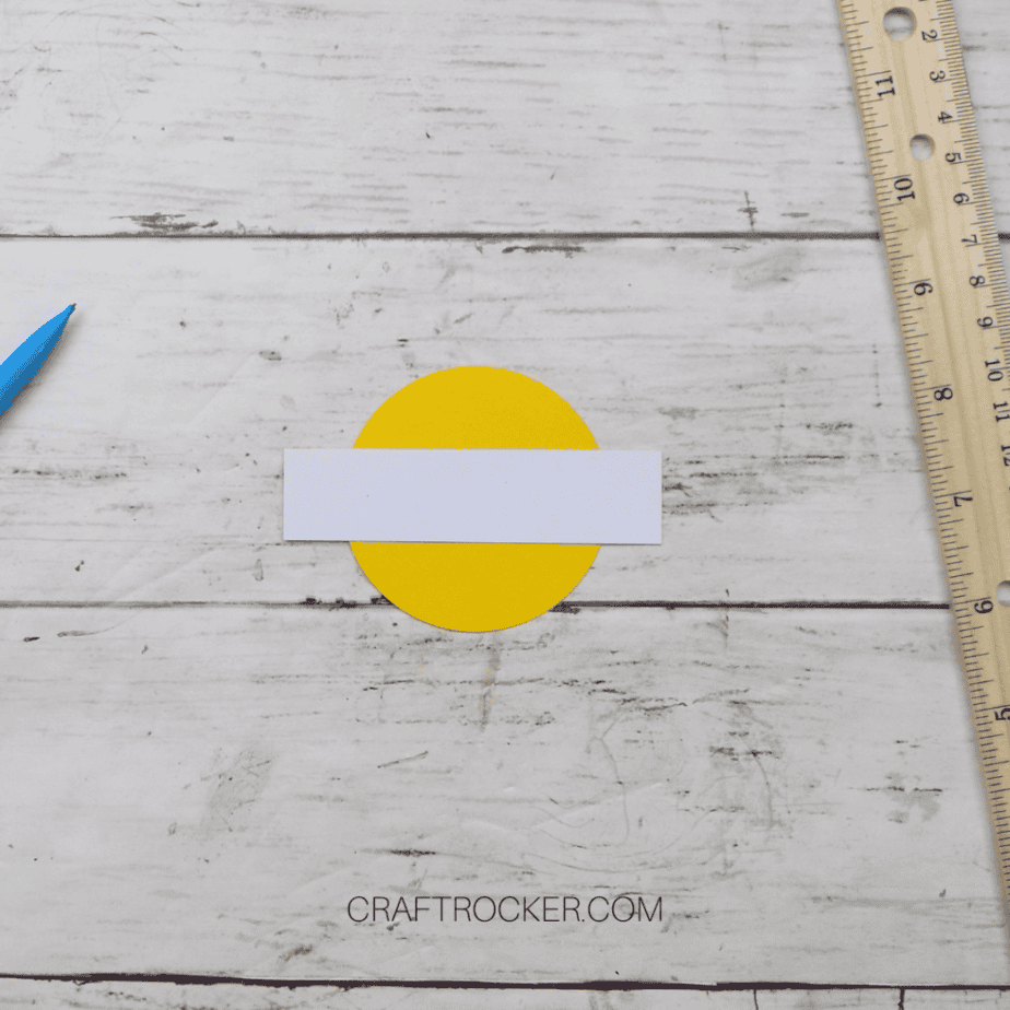 Close Up of White Strip of Paper on Yellow Paper Circle - Craft Rocker