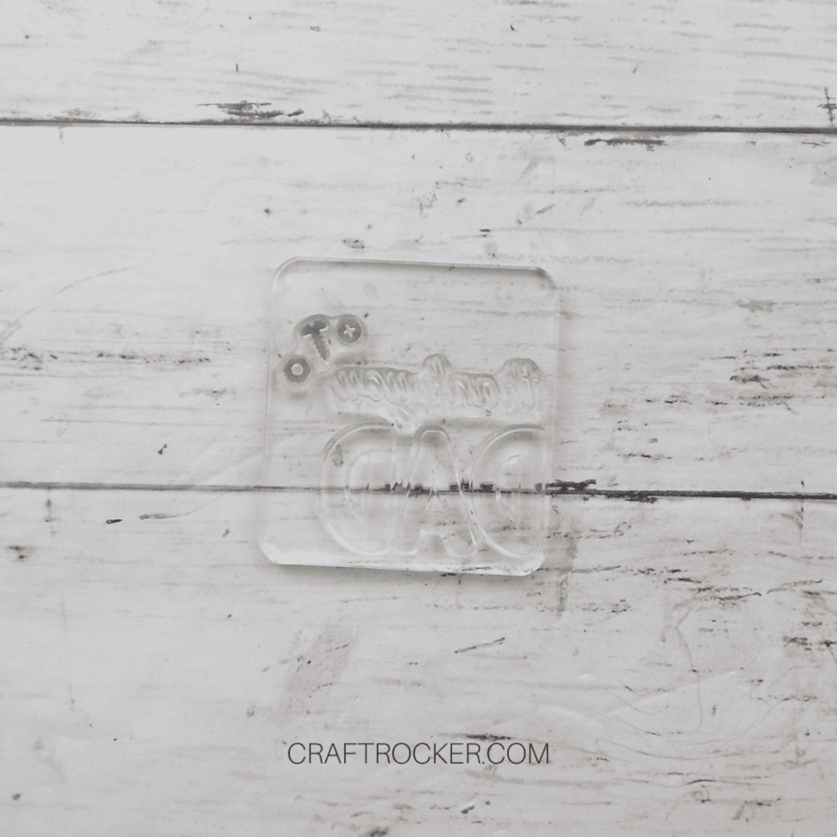 Stamps Arranged on Acrylic Block on Wood Background - Craft Rocker
