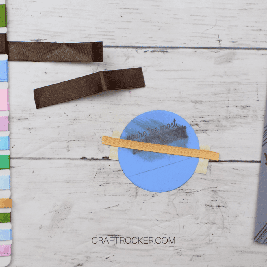 Tan Ribbon Strip Glued to Back of Blue Paper Circle - Craft Rocker